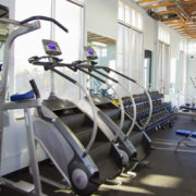 Young adults using running machine at the fitness club
